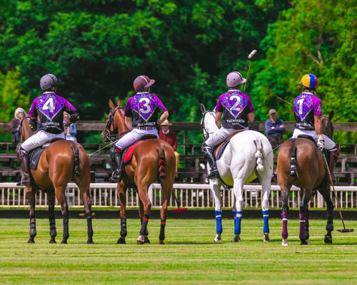The Mirror Polo Team — all four players wearing Jason Brickhill Holographic Mosaic purple polo jerseys numbers 1, 2, 3 and 4 on horseback at Cirencester Polo Club