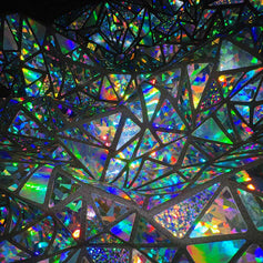 Close-up of holographic mosaic fabric by Jason Brickhill with light-reactive reflective fragments