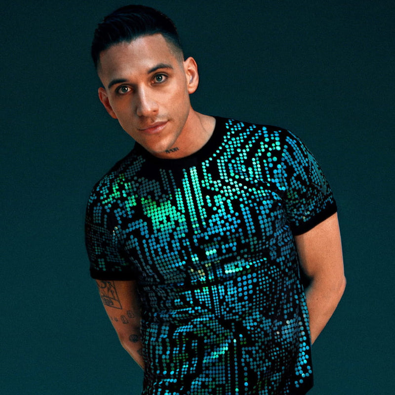 Man wearing a Jason Brickhill digital glitch shirt against a dark background.